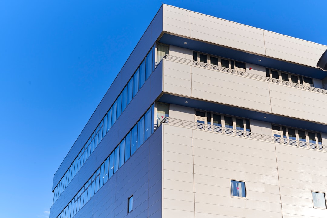 Modern building with reflective windows under blue sky